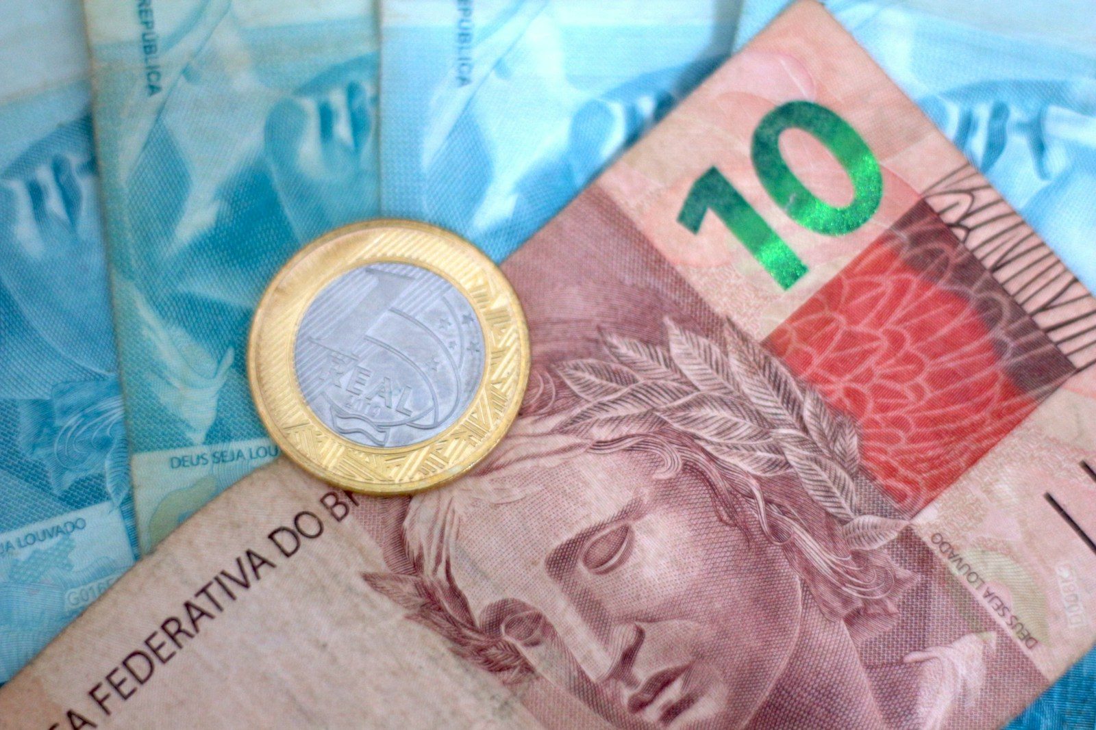 A close up of a money bill with a coin on top of it