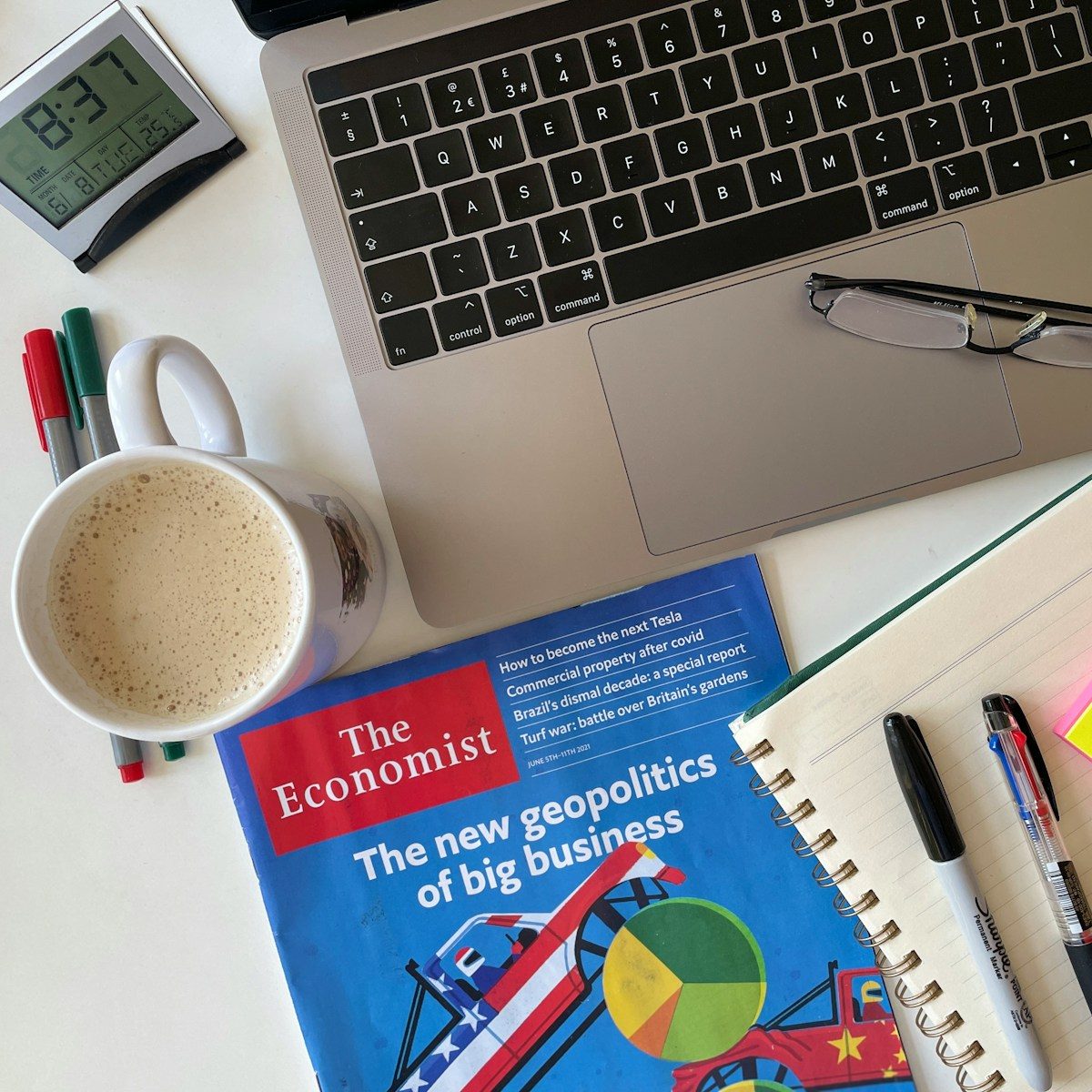 white ceramic mug beside silver macbook