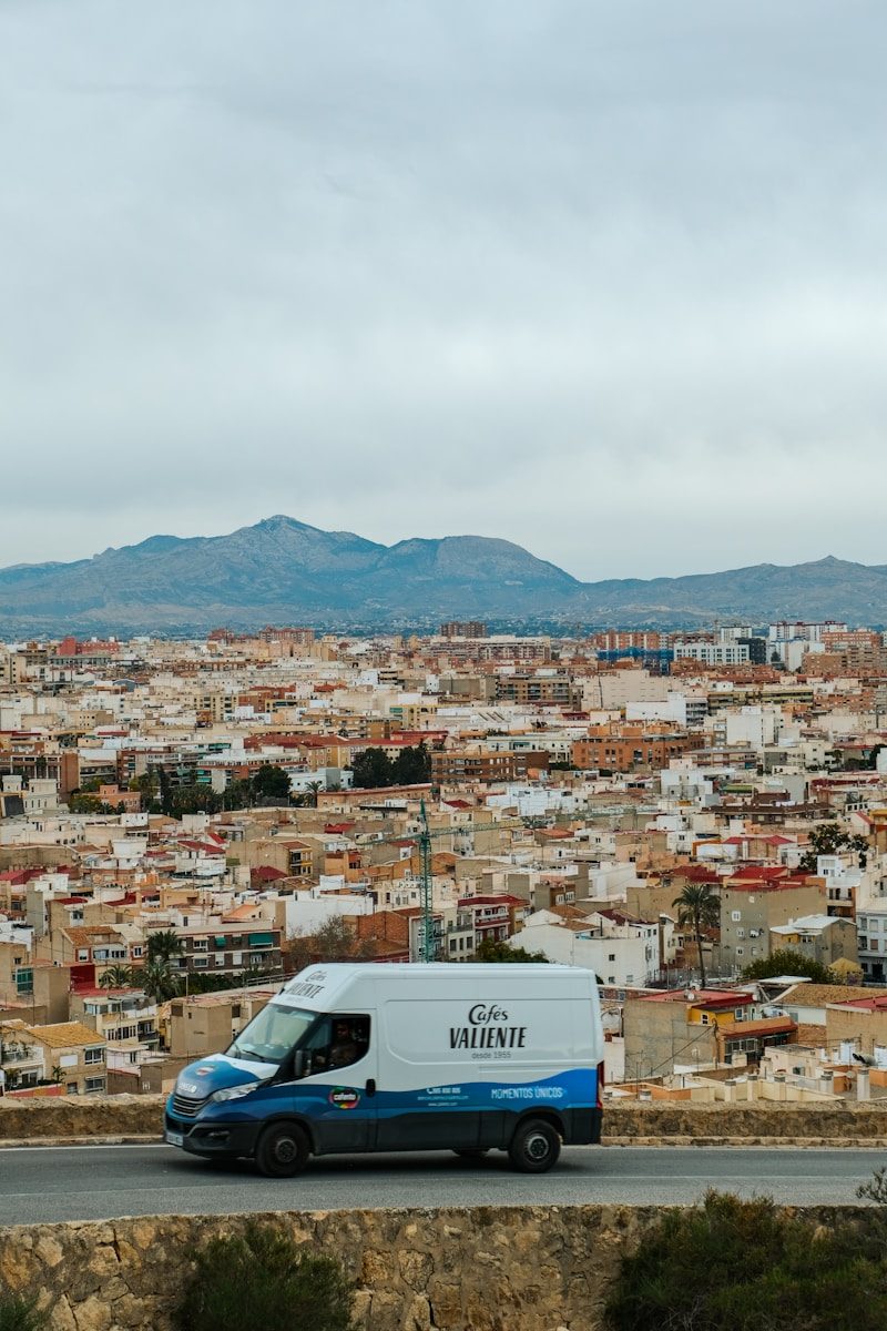 A van drives through a cityscape.