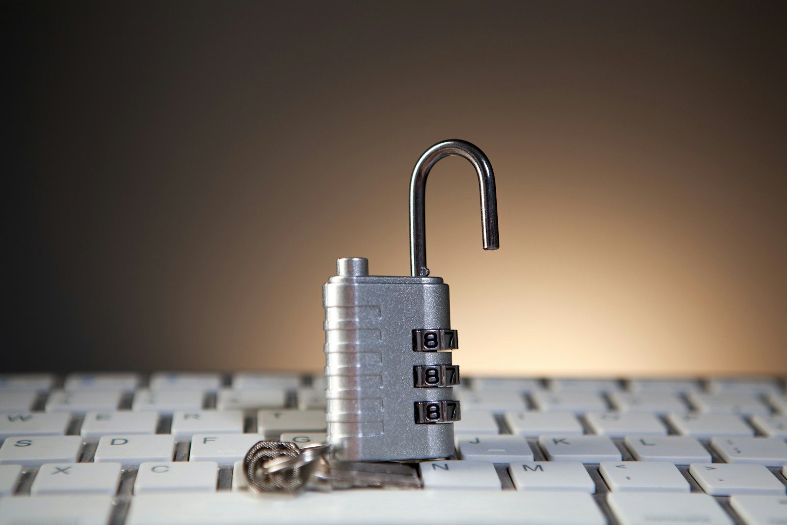 Open padlock with combination lock on keyboard