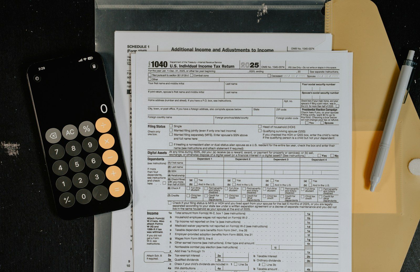 Tax forms and calculator on a desk.