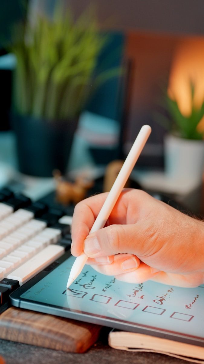 Someone is using a stylus on a tablet.